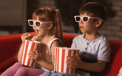 Kids watching a movie with popcorn