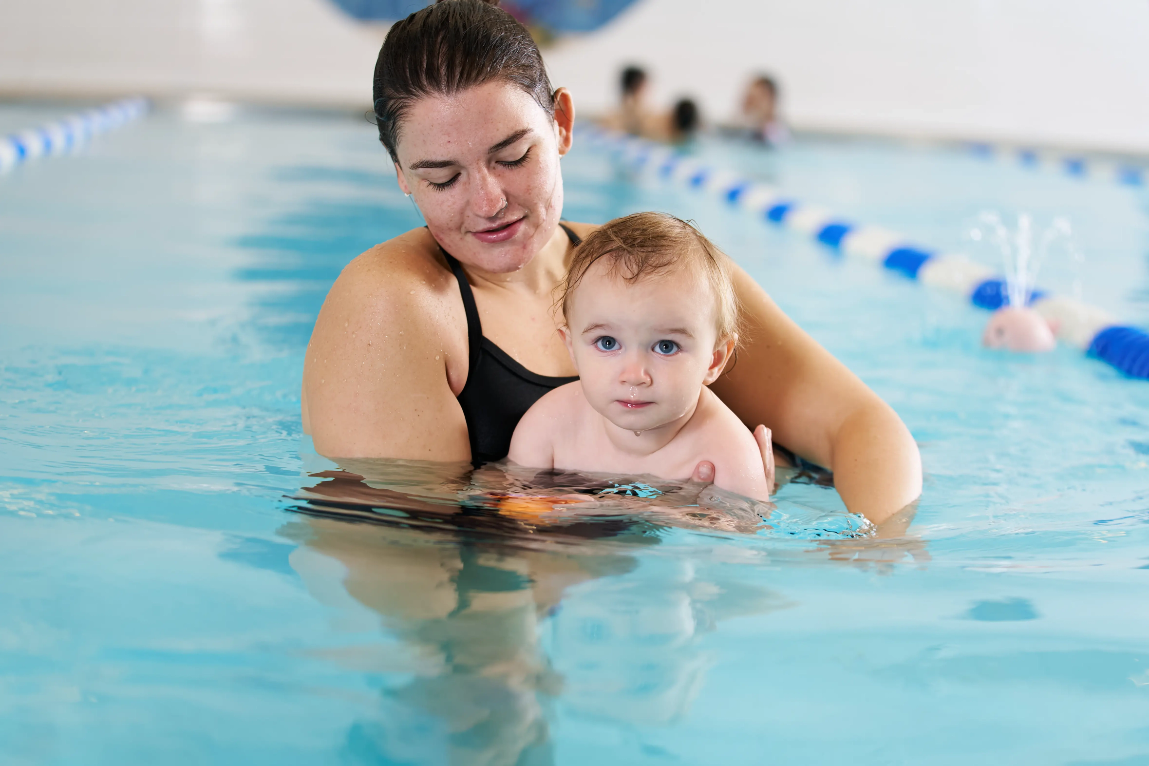Parent with child in the pool