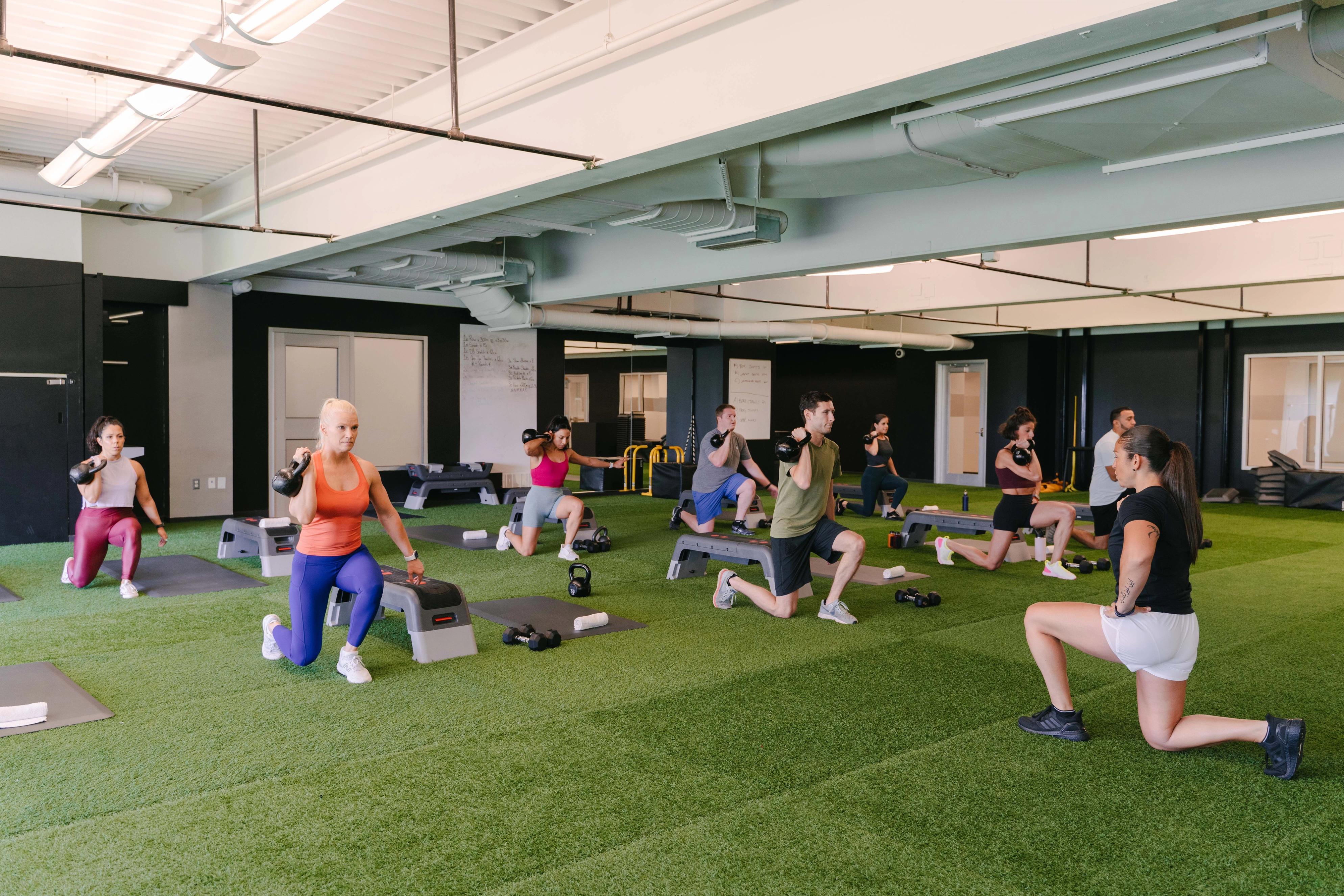 Strength training class on functional turf