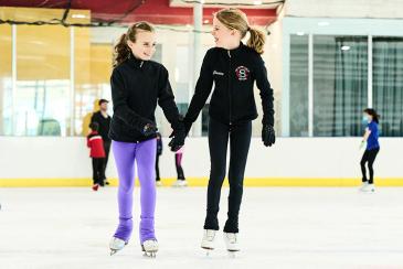Two girls ice skating