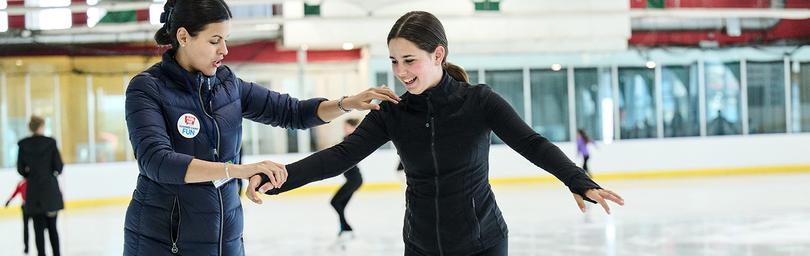 Coach guiding an ice skater