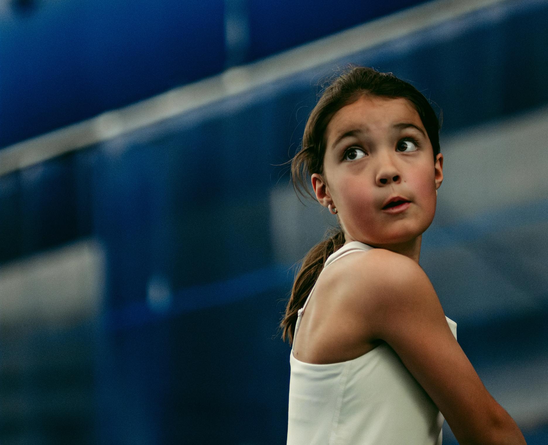 girl playing tennis ready to hit a shot