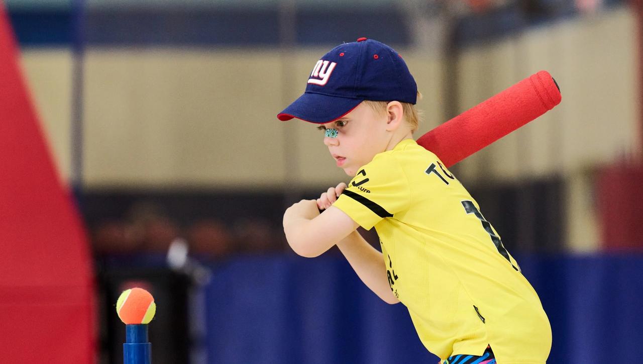 Kid hitting a tee ball