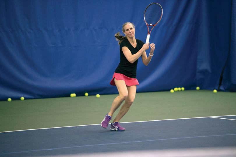 Adults playing tennis