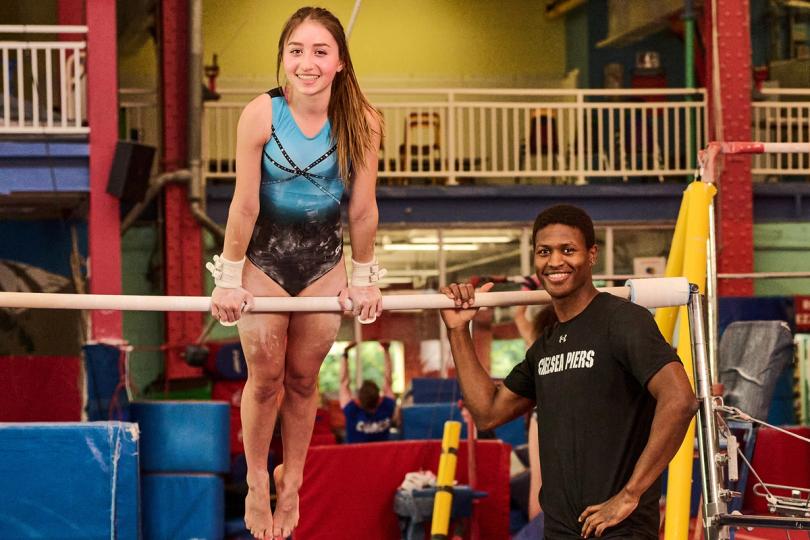Gymnast with coach on the uneven bars