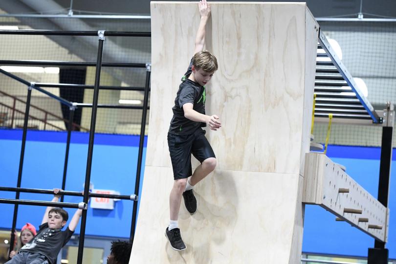 Kid training in the ninja parkour gym