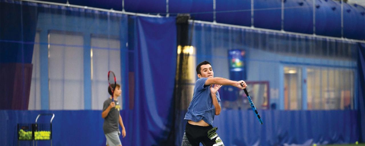 boy playing tennis