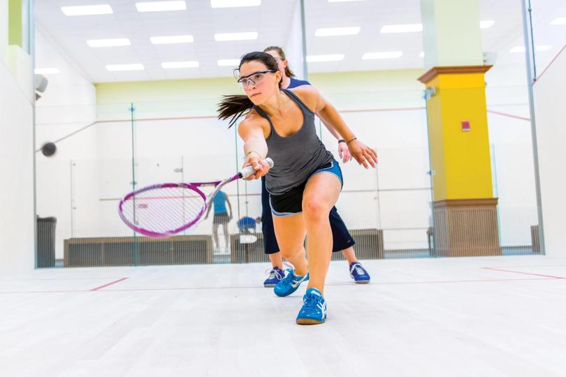 Adults playing squash