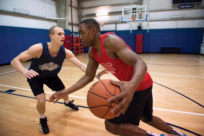 Two guys playing basketball