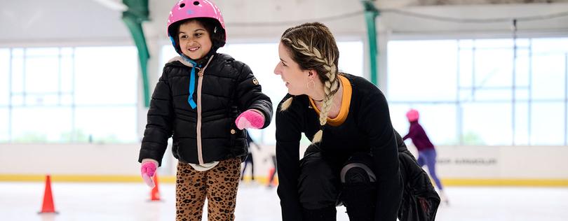 Coach skating with kid