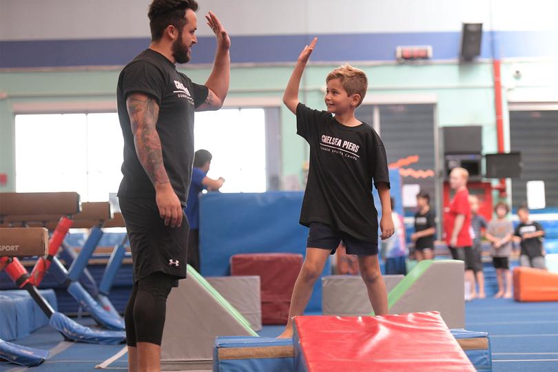 Kid high fiving their coach
