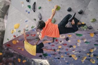 People rock climbing at gym