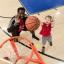 Kid playing basketball with coach