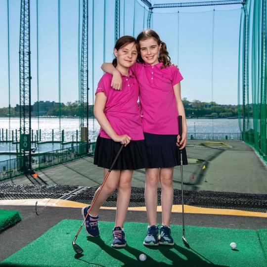Young golfers ready to swing at the driving range