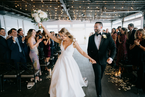 Bride and groom walking down the aisle at Chelsea Piers