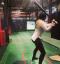 Girl hitting in a batting caage