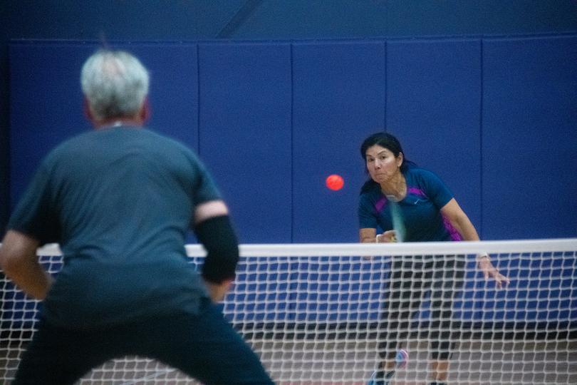 Adults playing pickleball