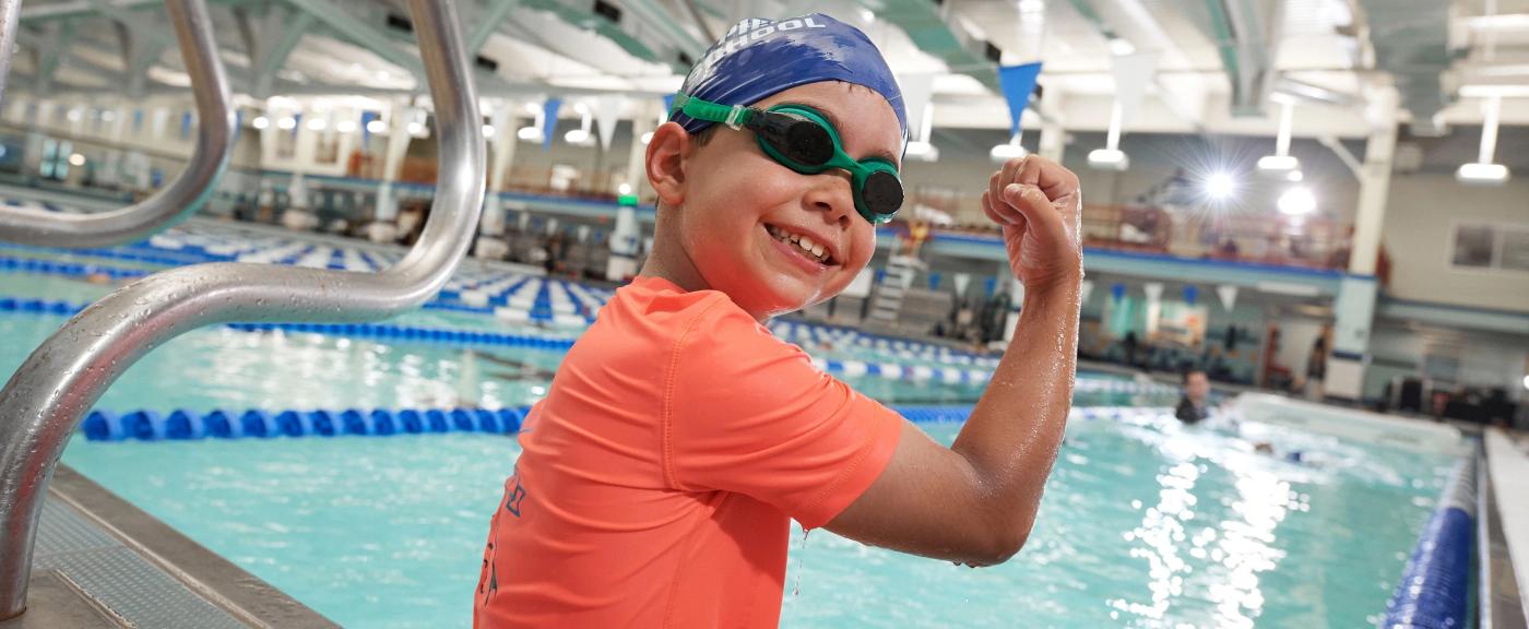 kid smiling by swimming pool