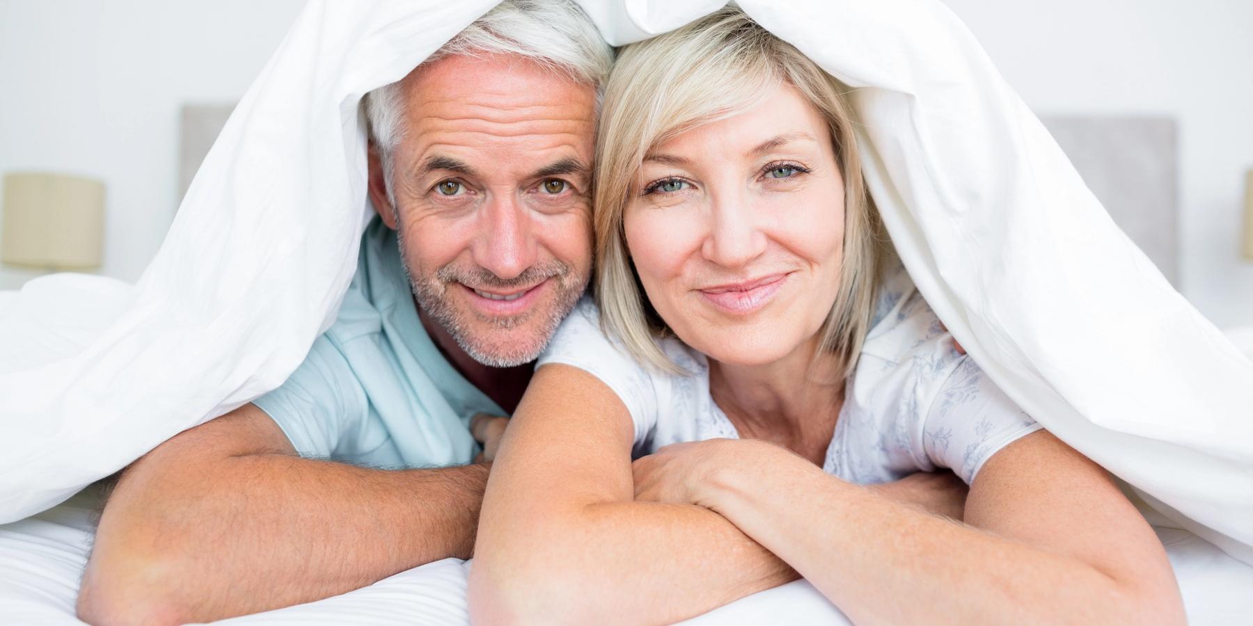 boldog középkorú pár az ágyban