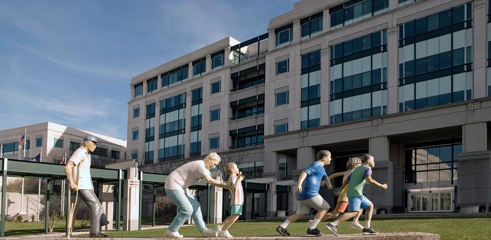The CMS headquarters building in Woodlawn, Maryland, behind the Life in the Community sculpture installation.