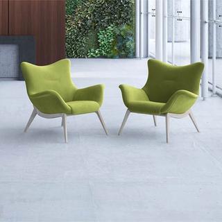 Two mid back winged chairs with green fabric