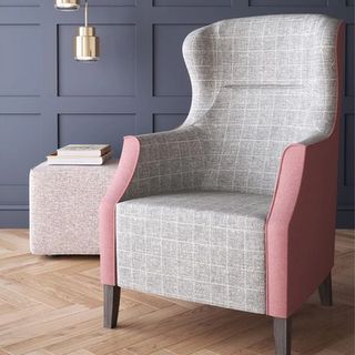 Pink and gray chair with books on side stool