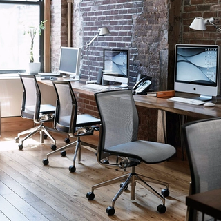 Executive chairs in office space with brick walls
