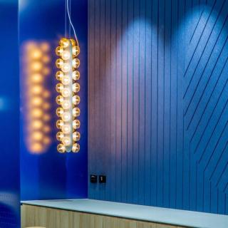 Designer lighting with blue ting shining on router cut patterned panels