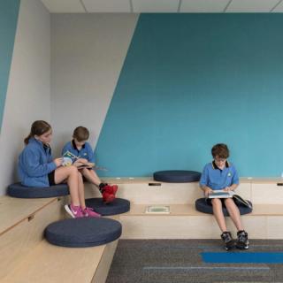 Children in room with blue and white acoustic wallcovering