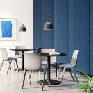 Gray chairs with blue cushions around tables with overhead pendant lights