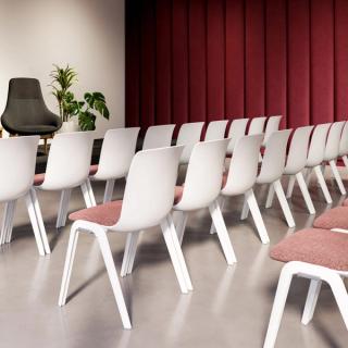 White chairs with pink cushions in three rows