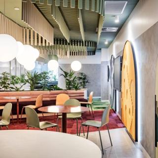 Open area with multi-colored seating, tables, and wall decor