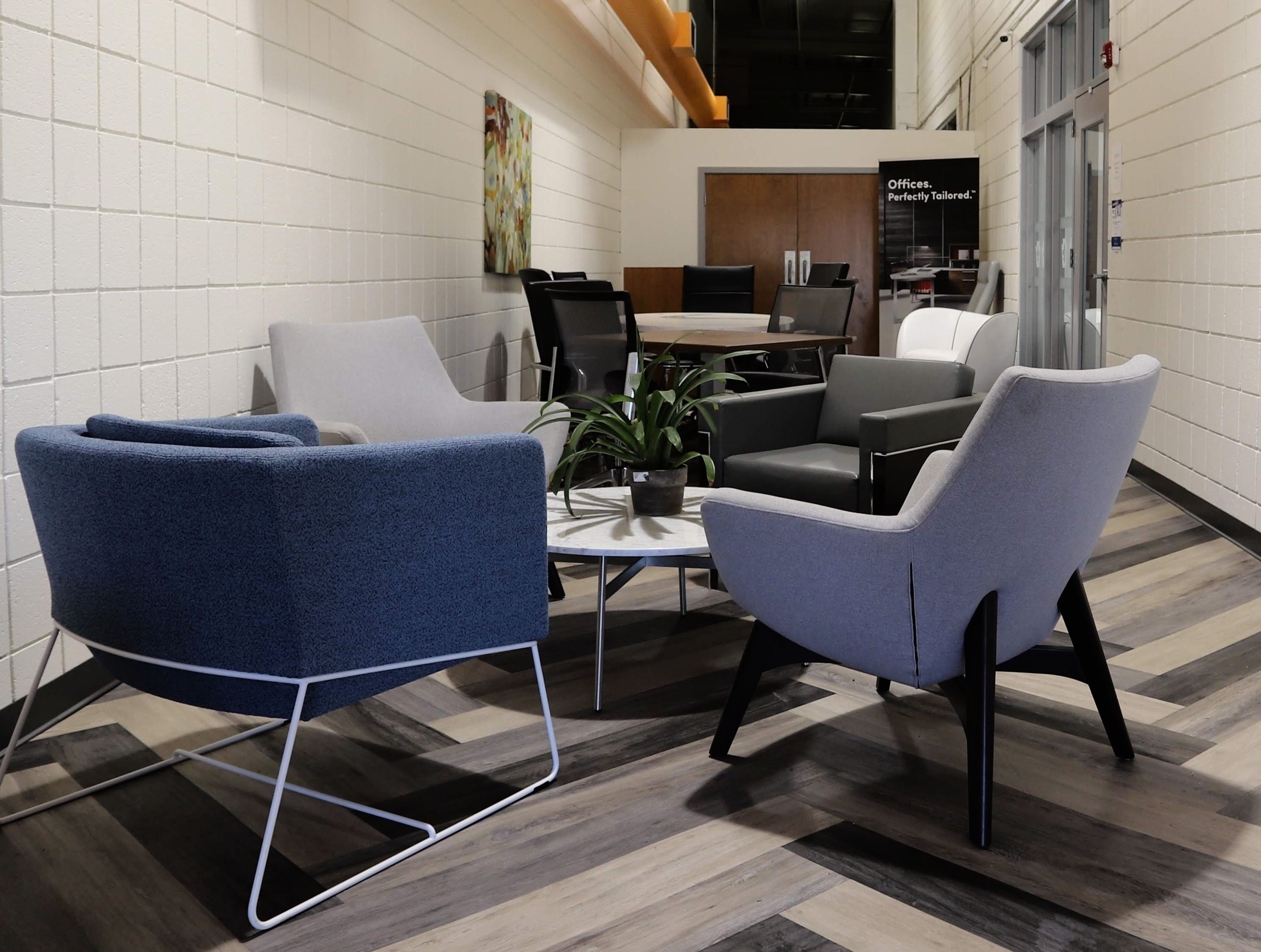 CP Group waiting room with various chairs, a coffee table, and a conference table