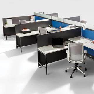 Empty office desks with chairs and dividers
