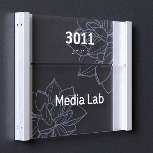Glass sign on wall for media lab