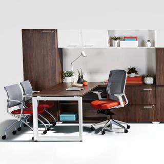 Brown executive desk with orange chair and cabinets
