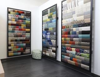 Various textile fabrics hanging on a wall