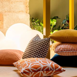 Pillows in a variety of fabrics by globe lights