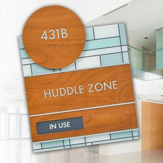 Huddle zone in use sign and office space in background