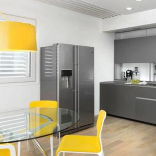 Glass table with yellow chairs in kitchen