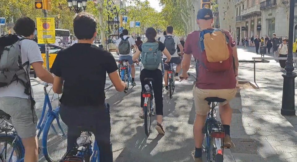 Group of colleagues cycling through Barcelona during a teambuilding trip organised by Nessout