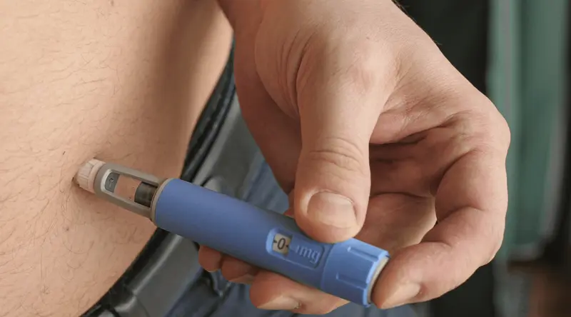 Person injecting medication into abdomen - Who Should Not Take Semaglutide