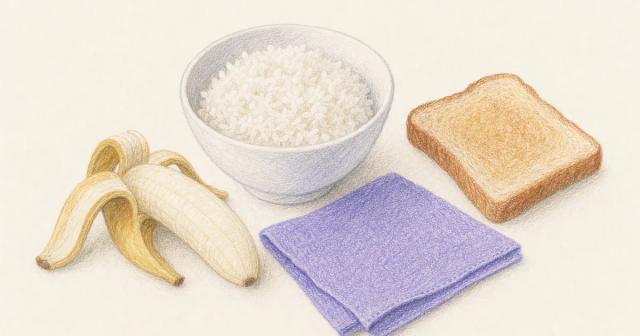 Bowl of plain rice with a banana and toast on a soft linen surface