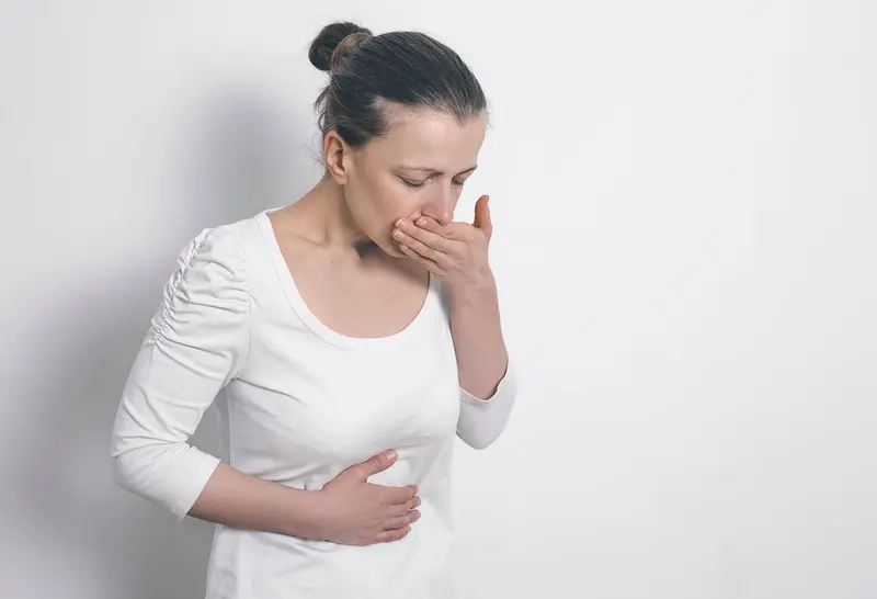 woman about to vomit - Tirzepatide vs Semaglutide Side Effects