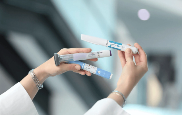 Person holding various injectable medication pens - Microdosing GLP 1
