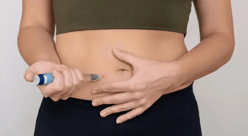 Woman injecting medication into her abdomen - How to Track My Semaglutide Side Effects?