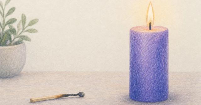 Spent matchstick beside a steadily burning pillar candle