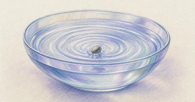 A single stone dropped in a bowl of water sends ripples outward.