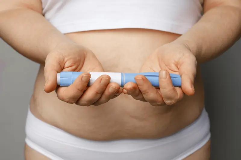 person holding injection - How Long Does Semaglutide Stay in Your System