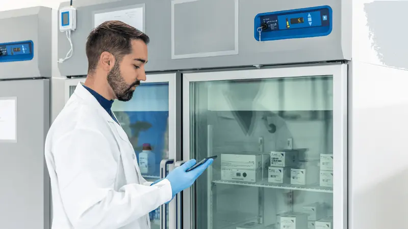 Researcher checking medical storage refrigerator - 503a vs 503b